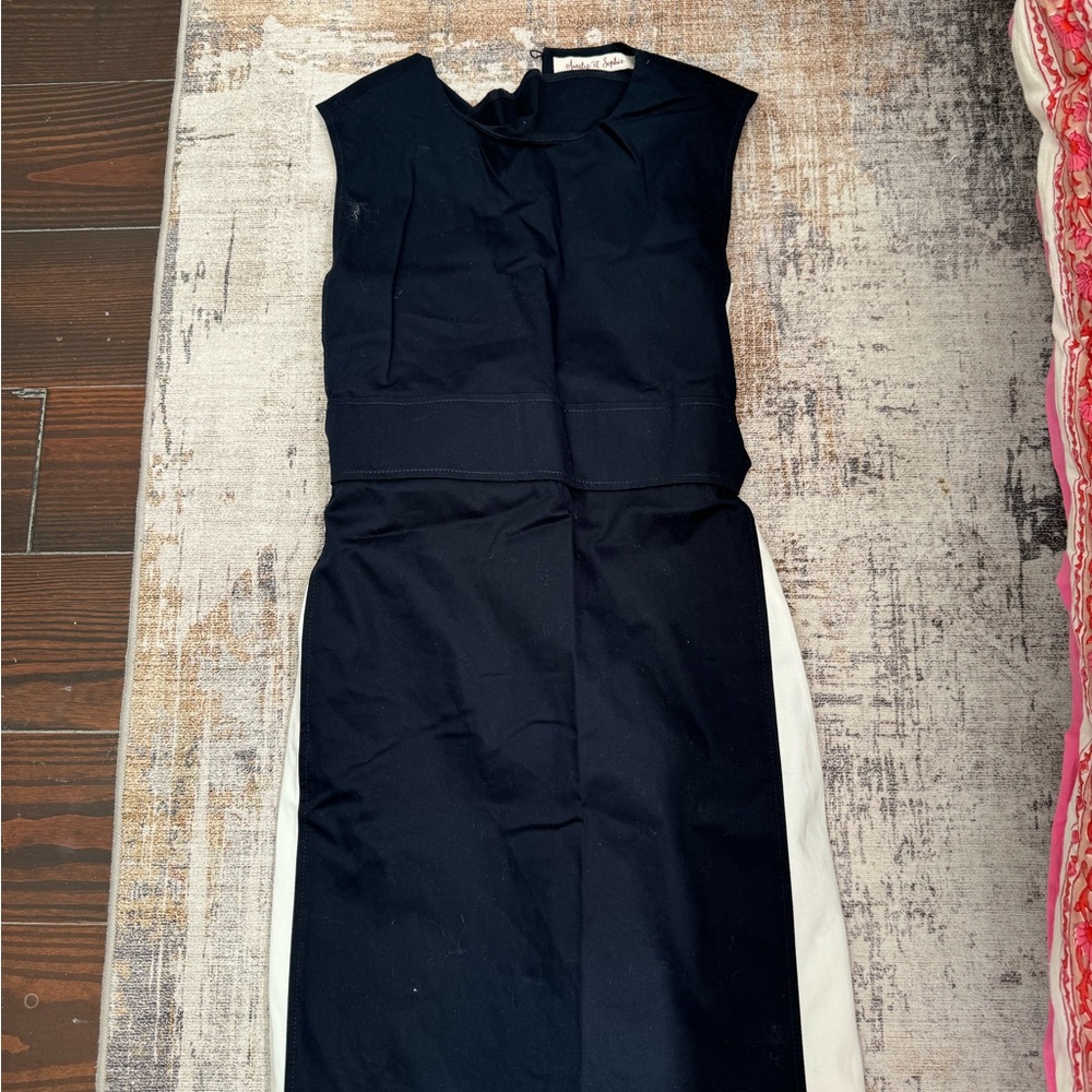 This is a size 13-14. It is a navy blue with white stripes and buttons